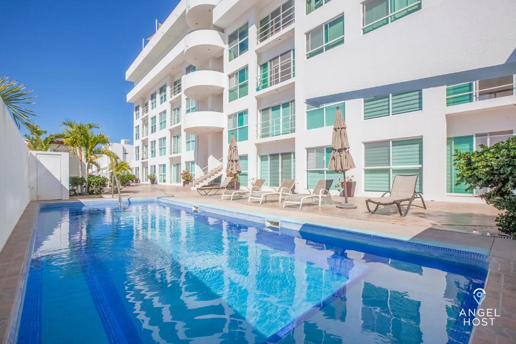 a swimming pool in front of a building at Condos by Malecon I Breathtaking Ocean View in La Paz