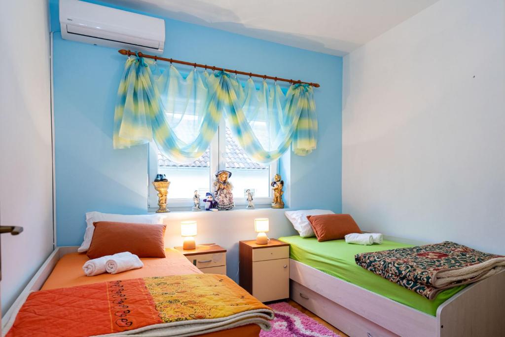 Postel nebo postele na pokoji v ubytování Apartman JOZIC