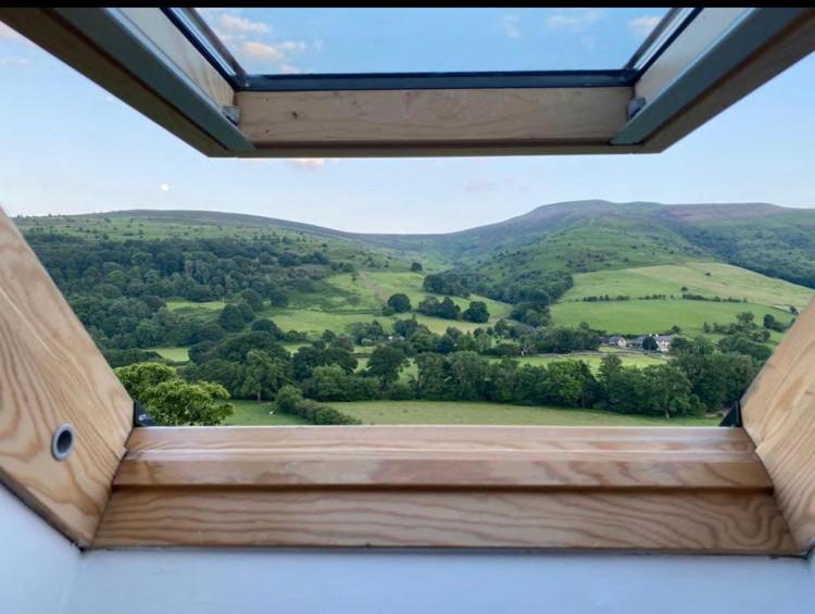 a window with a view of a green field at The Celyn in Pont Newydd