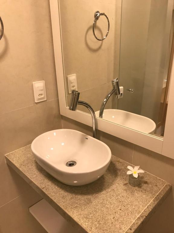 a bathroom with a sink and a mirror at Suites Amma Noronha in Fernando de Noronha