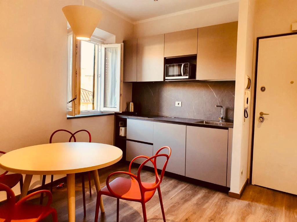 a kitchen with a table and chairs and a table and a table and a kitchen at The Square of Miracles Apartment in Pisa