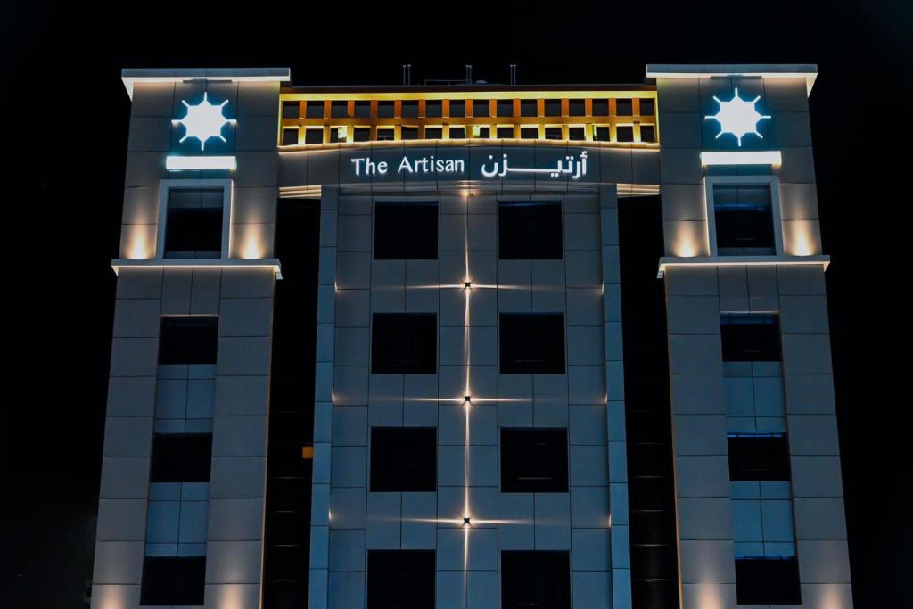 a building with stars on top of it at night at The Artisan Hotel-Suits in Jeddah