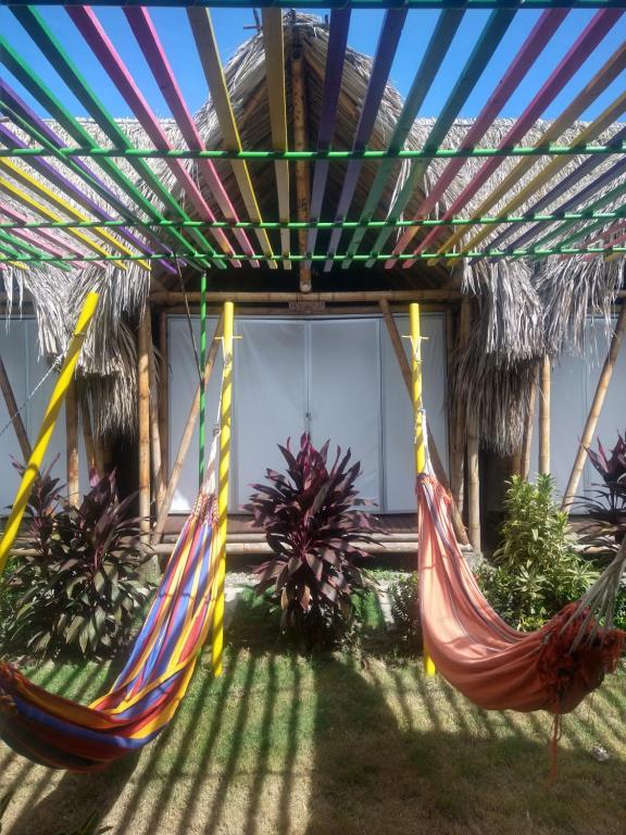 two hammocks hanging from a pergola in a house at Cabaña Beach Palomino in Palomino