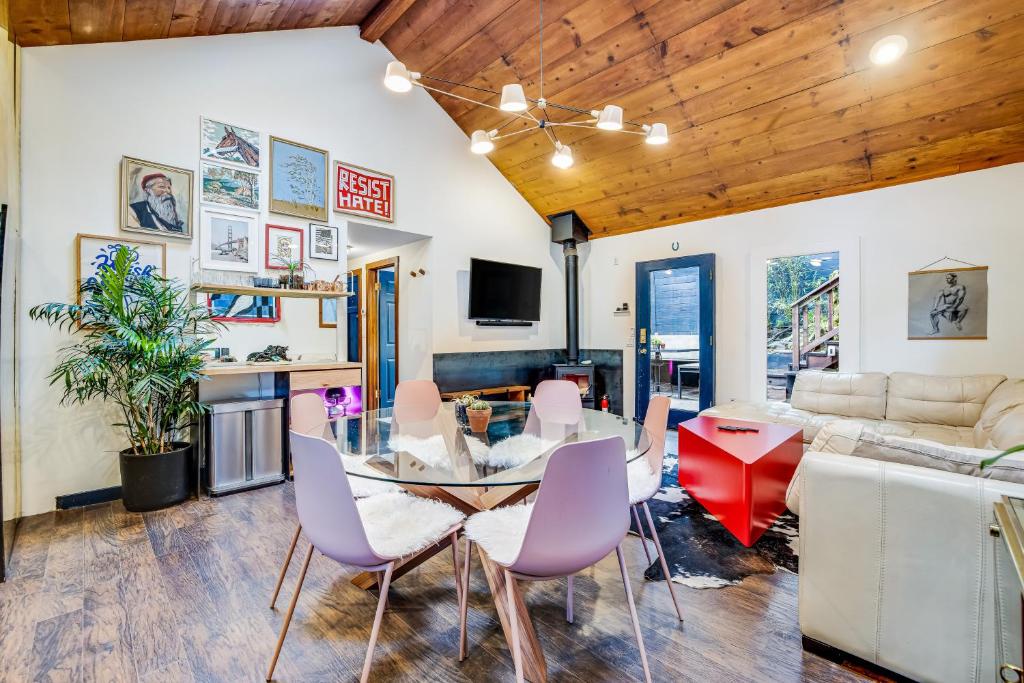a dining room and living room with a table and chairs at Eclectic Escape in Guerneville