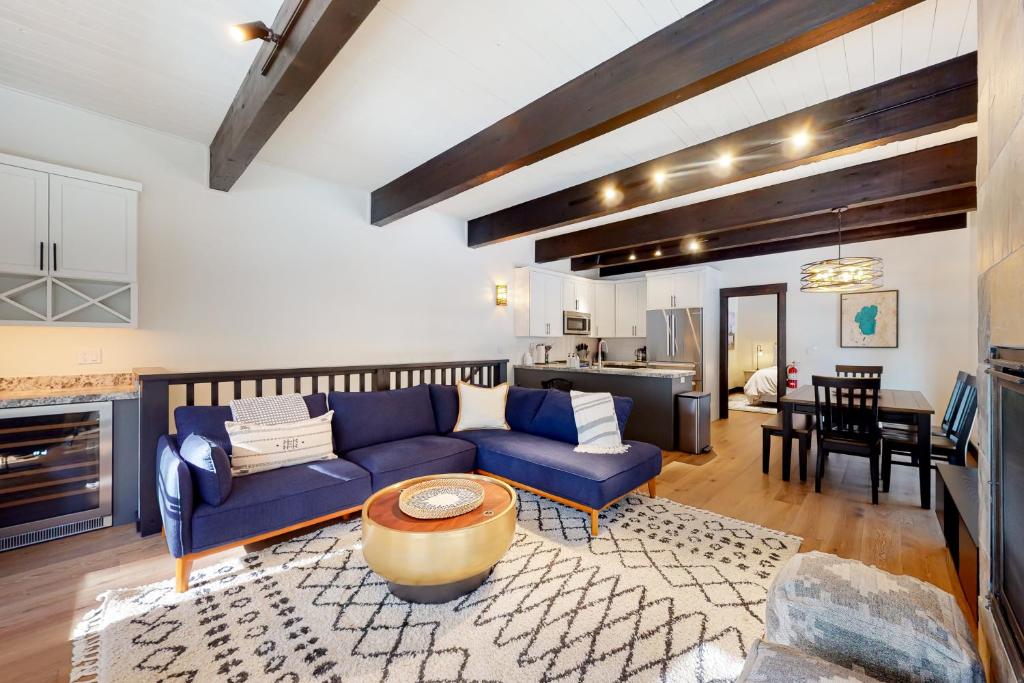 a living room with a blue couch and a table at Maison de Montagne in Incline Village