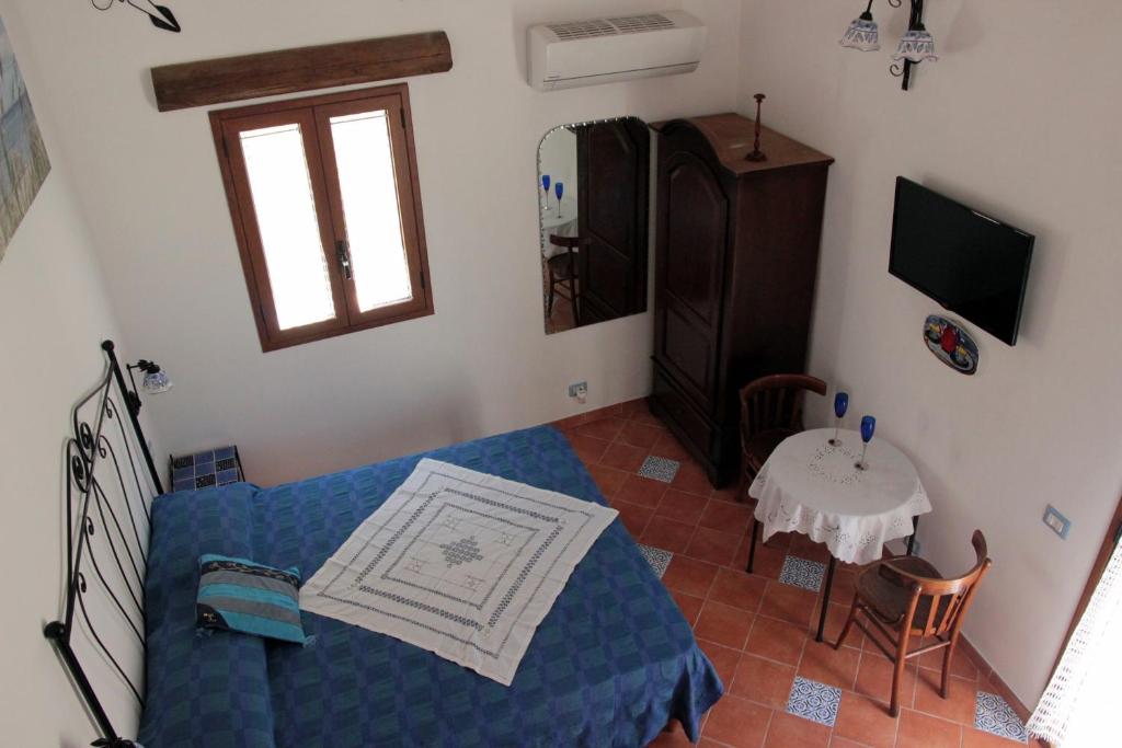 a living room with a blue couch and a table at La Casa del Geko in Cefalù