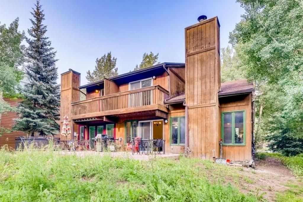 a wooden house with a wrap around porch at Meadow Lodge - Dog Friendly! in Frisco