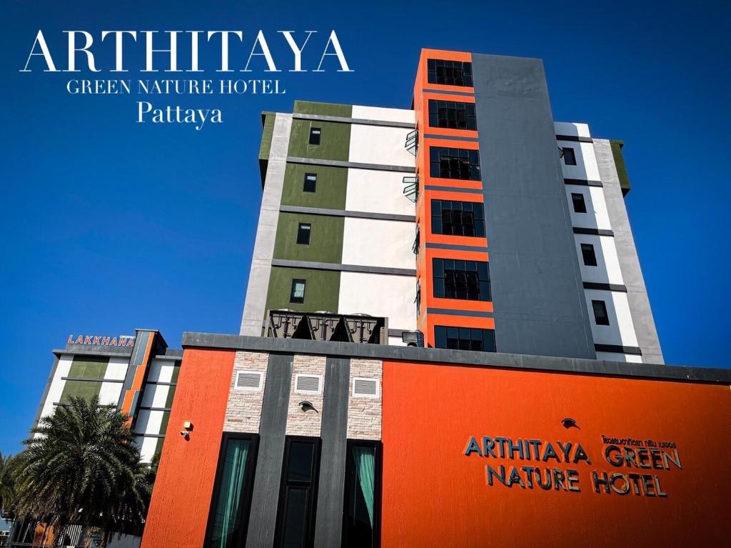 un grand bâtiment avec un panneau devant lui dans l'établissement Arthitaya Green Nature Hotel, à Pattaya (nord)