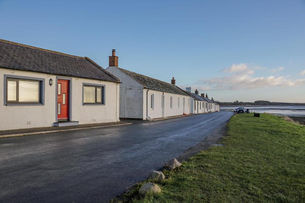 a row of houses on the side of a road at 2 Whiterow in Powfoot