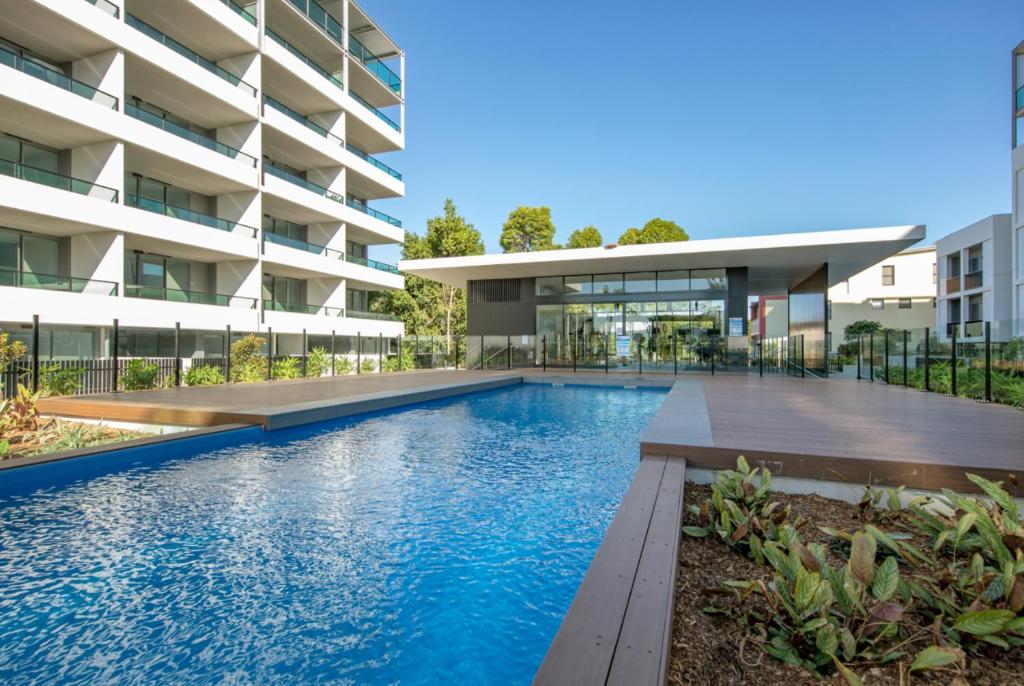 a swimming pool in front of a building at Waters Edge Apartments in Warners Bay
