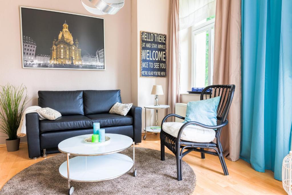 ein Wohnzimmer mit einem Sofa und 2 Stühlen in der Unterkunft DD-Apartment Löbtau 1 in Dresden