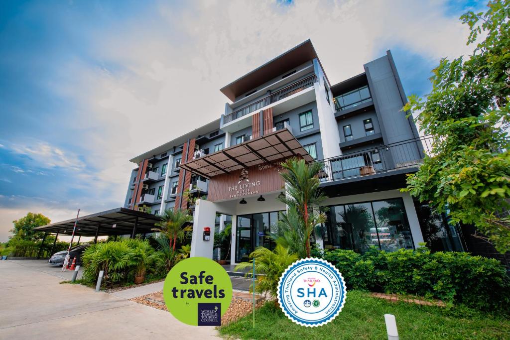 a building with a sign in front of it at The Living Hotel SamutPrakan in Bang Bo