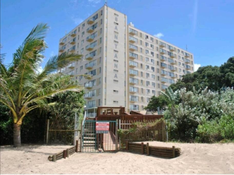 a large building on the beach next to a building at Santana 904 beachfront apartment. Beautiful sea views in Margate