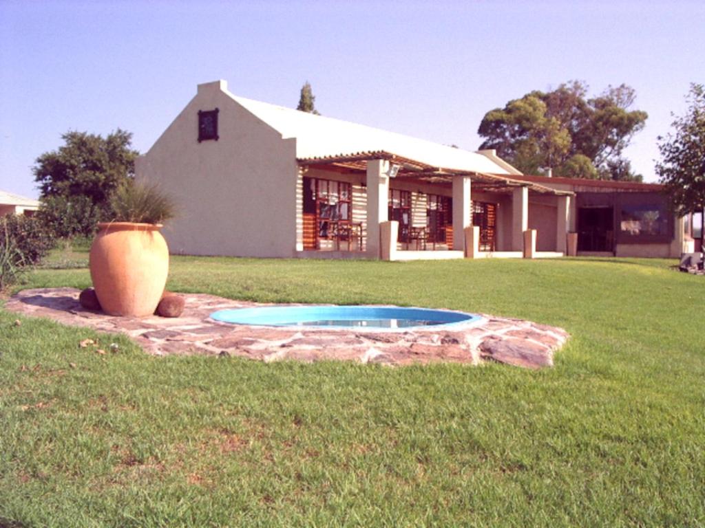 a house with a small pool in the yard at Suites in Private Game Reserve close to Aliwal North in Gladdegrond