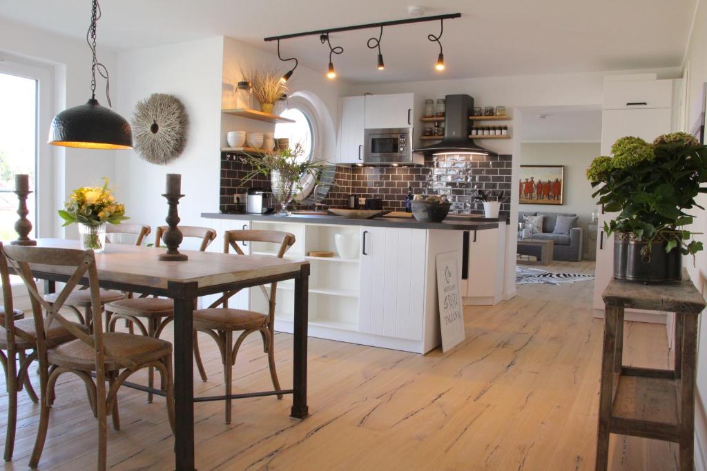 a kitchen and dining room with a table and chairs at Fine Home in Timmendorfer Strand