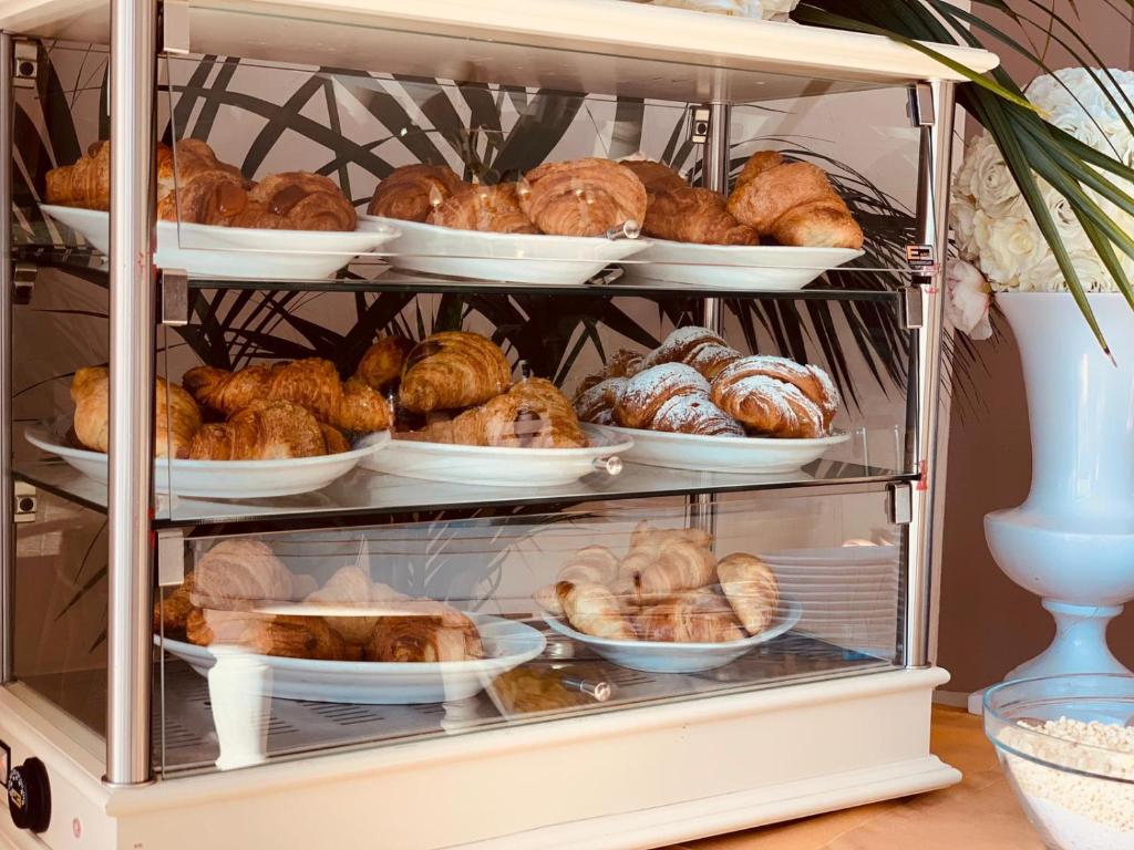 a display case filled with lots of bread and pastries at Gran Paradiso Hotel Spa in San Giovanni Rotondo