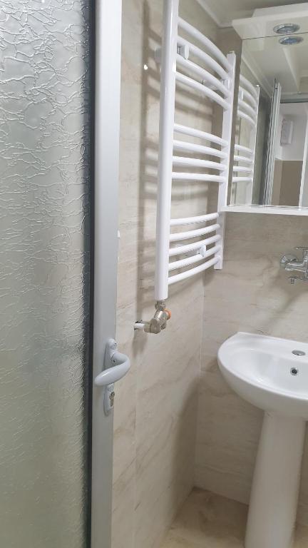 a bathroom with a sink and a toilet and a mirror at Apartment 18 in Pančevo