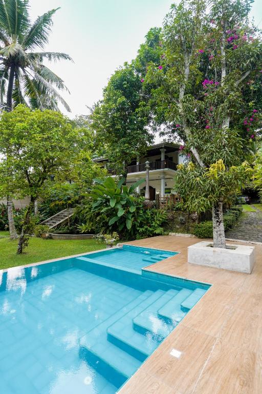 an image of a swimming pool in front of a house at The Villa Blue Sky in Unawatuna