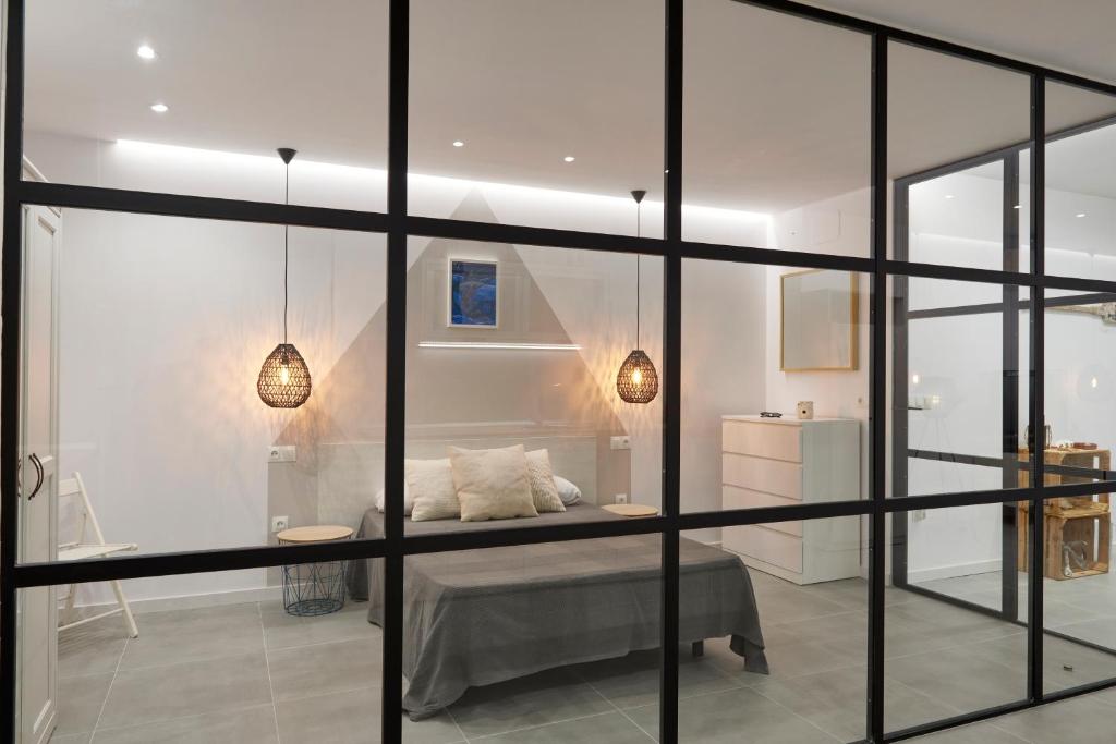 a room with a bed and some glass walls at Altea Puerto Playa in Altea