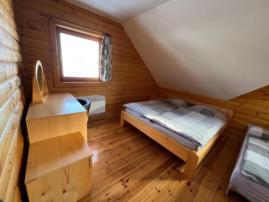 A bed or beds in a room at Zrubová Chata Sylvester