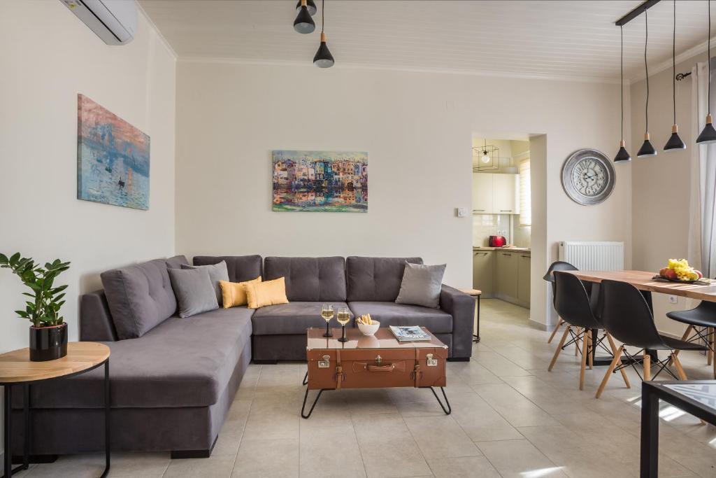 a living room with a couch and a table at The Lagoon Luxury House in Argostoli