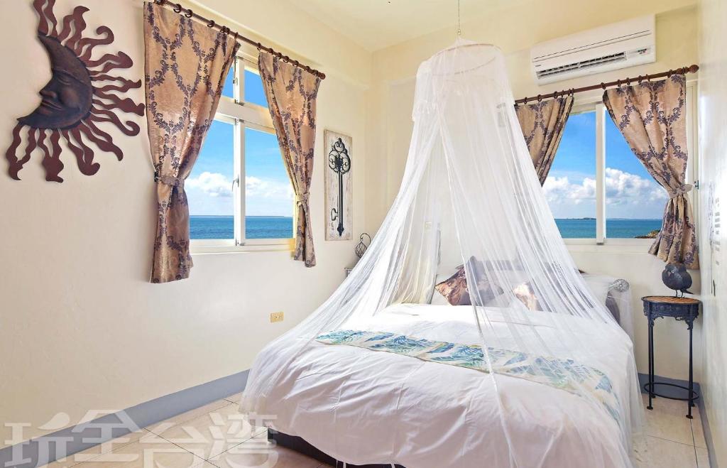 Postel nebo postele na pokoji v ubytování 沿海地帶 海景民宿 coastland B&B
