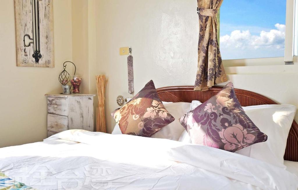 Postel nebo postele na pokoji v ubytování 沿海地帶 海景民宿 coastland B&B
