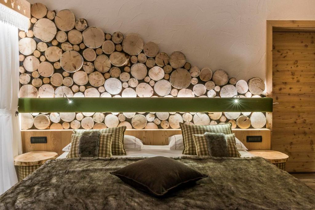 a bedroom with a large pile of logs on the wall at Chalet Pineta relax location in Canazei