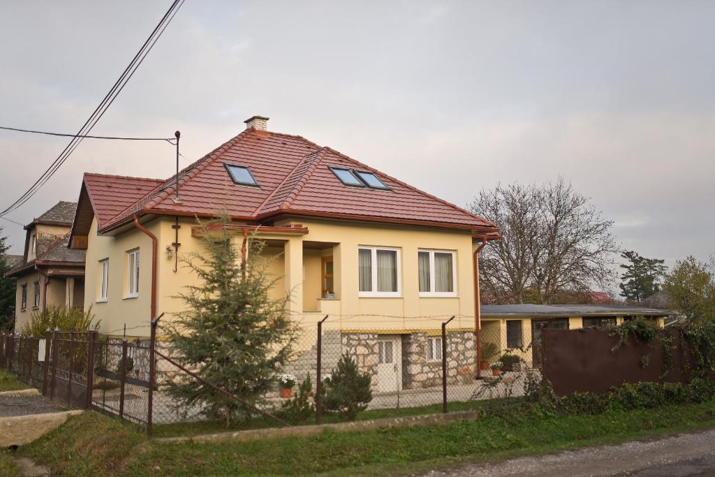 una casa amarilla con techo rojo en Slovakia; space, tranquility and plenty of opportunities! Be welcome in Strawberry House!, en Brzotín