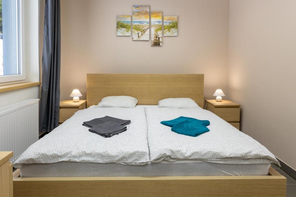 a bedroom with a bed with two towels on it at Apartmány SKI KRASLICE - NOVĚ OTEVŘENO in Kraslice