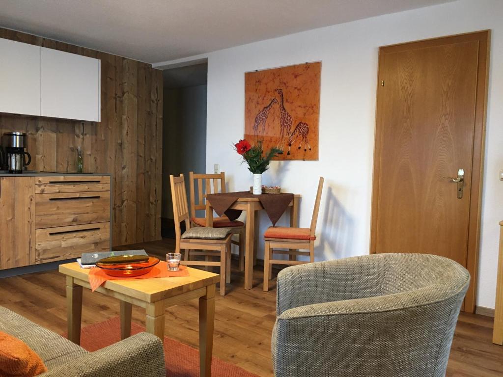 a living room with a table and a dining room at Haus Seidl in Bodenmais