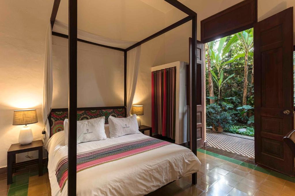 Postel nebo postele na pokoji v ubytování Hotel Villa Colonial