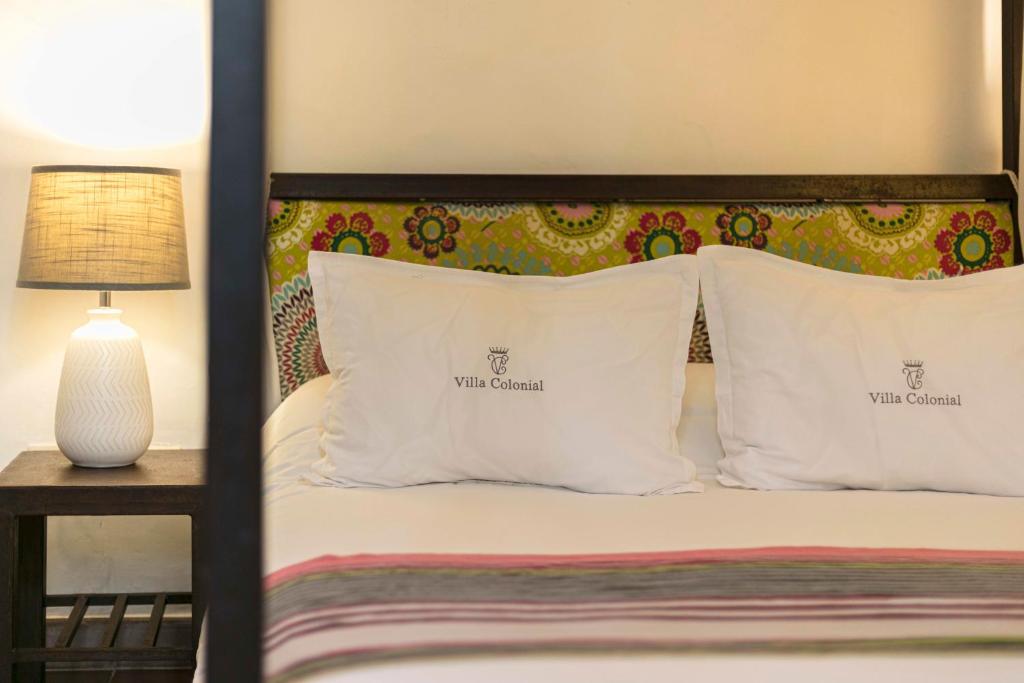 Postel nebo postele na pokoji v ubytování Hotel Villa Colonial