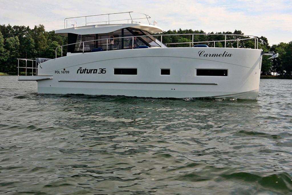 a white boat floating on a body of water at Thea - MAGIC POINT in Mangalia