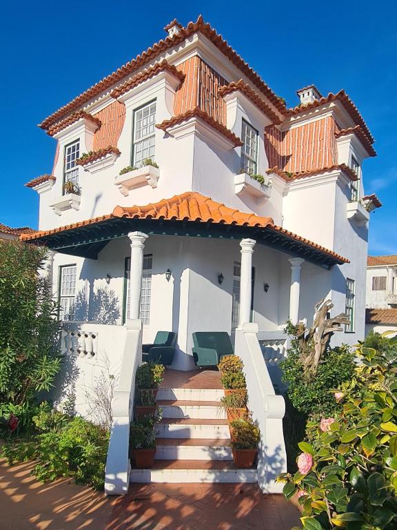 a white house with an orange roof at Casa do Jardim (Garden House) in Vila do Conde