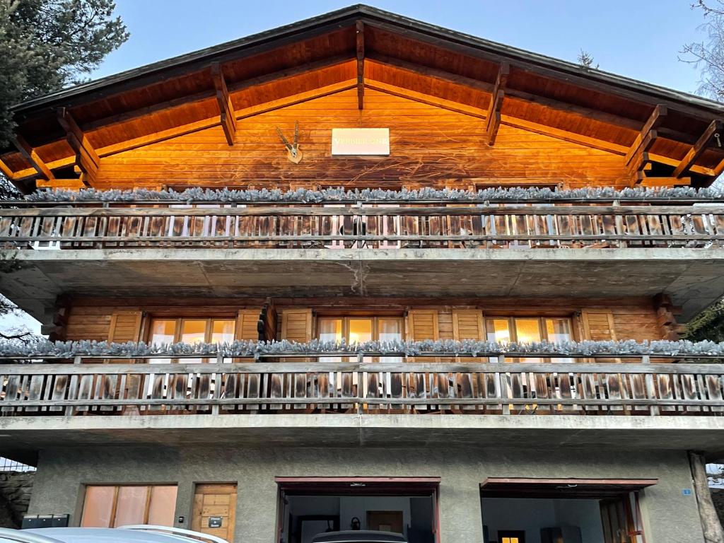 a building with a balcony on top of it at Verbier One Chalet in Verbier