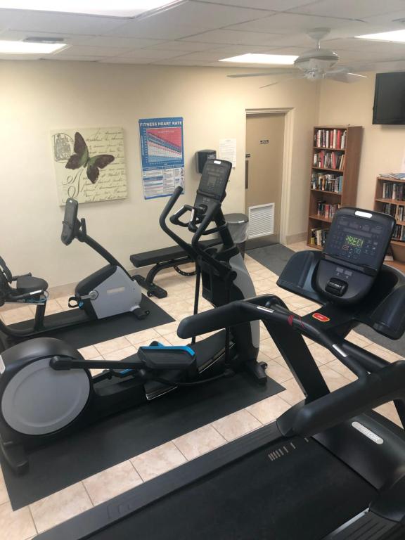 a gym with several exercise bikes in a room at Naples Dream at WTC with Heated Pool SPA Sauna 7 bicycles and 3 mls to beach in Naples