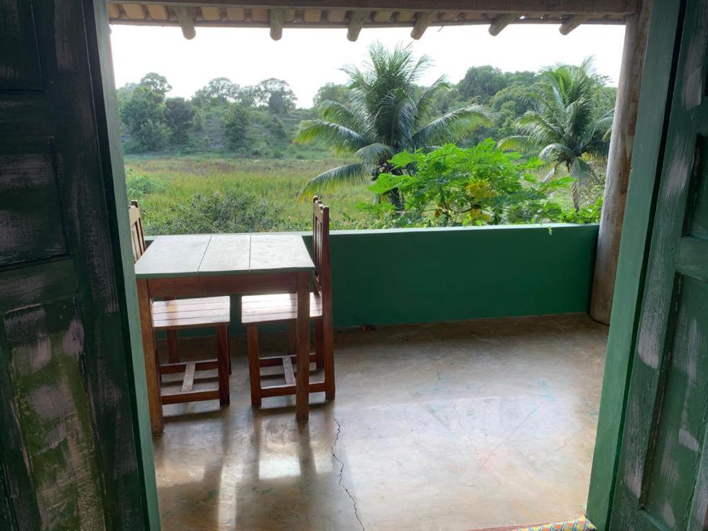 a room with a table and chairs on a porch at Casa Eco Vila in Trancoso