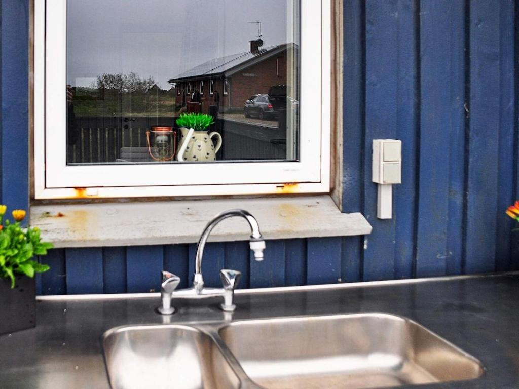 a kitchen sink in front of a window at 6 person holiday home in Harbo re in Harboør