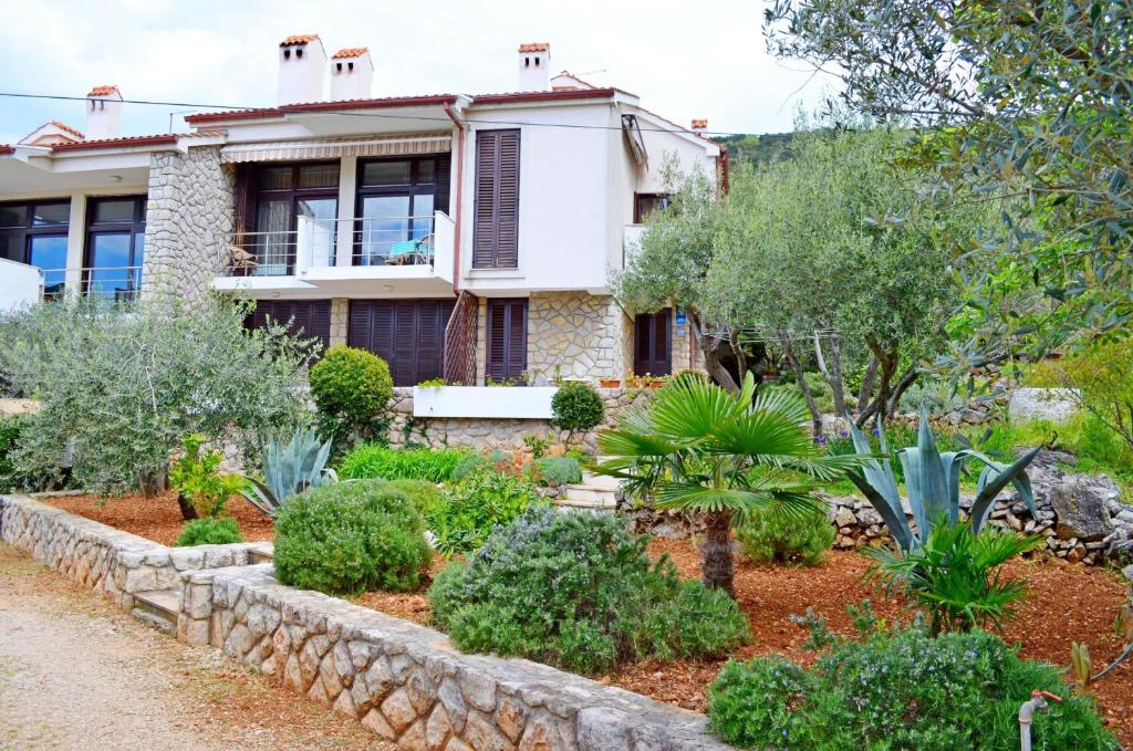 a house with a garden in front of it at Apartments Marija in Cres
