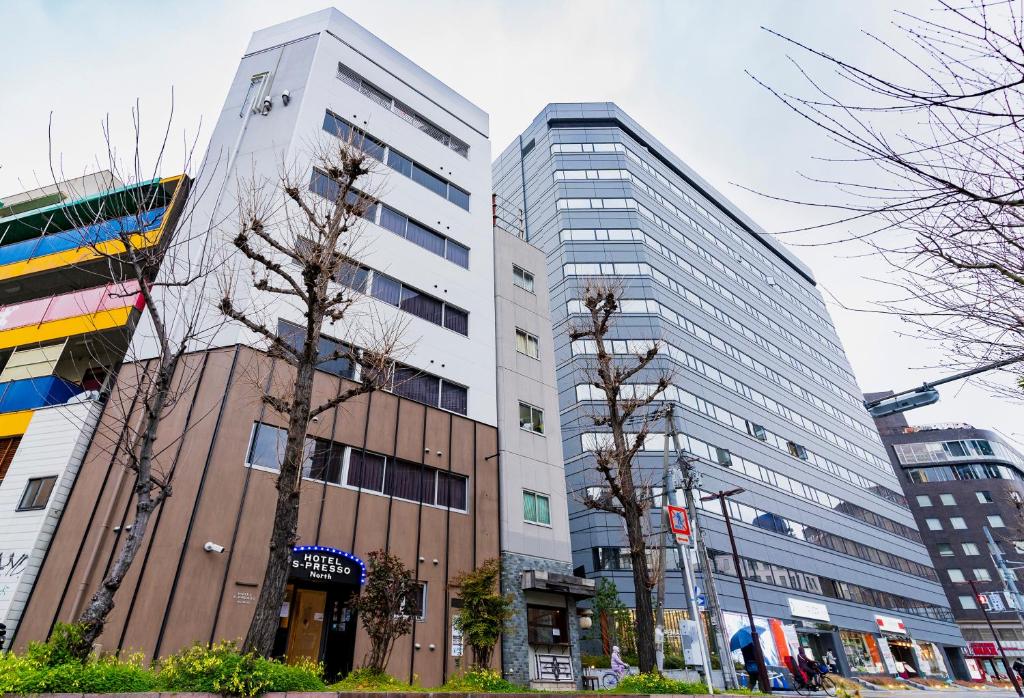 a group of tall buildings in a city at Hotel S-Presso North in Osaka
