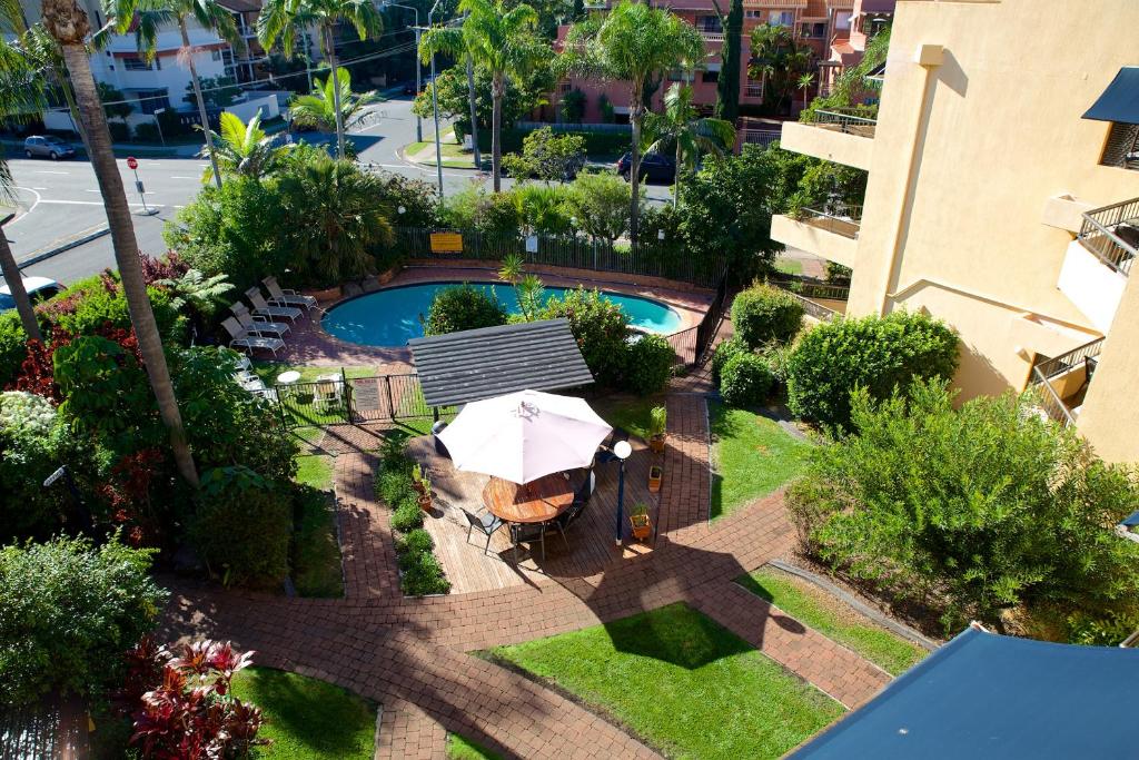 an overhead view of a swimming pool with an umbrella at Grangewood Court Apartments in Gold Coast