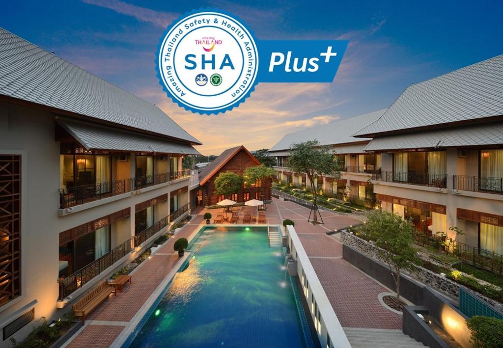 a hotel with a swimming pool and a shka just logo at Plakan Resort in Kanchanaburi City