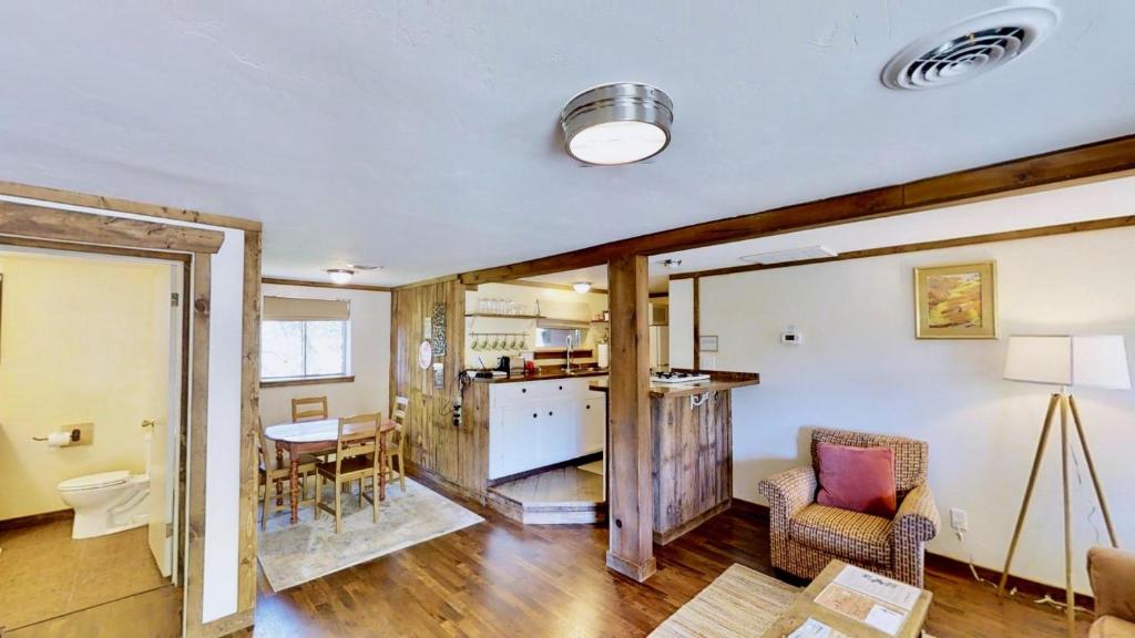 a kitchen and living room with a table and chairs at Pack Creek ~ Creekside East in Moab