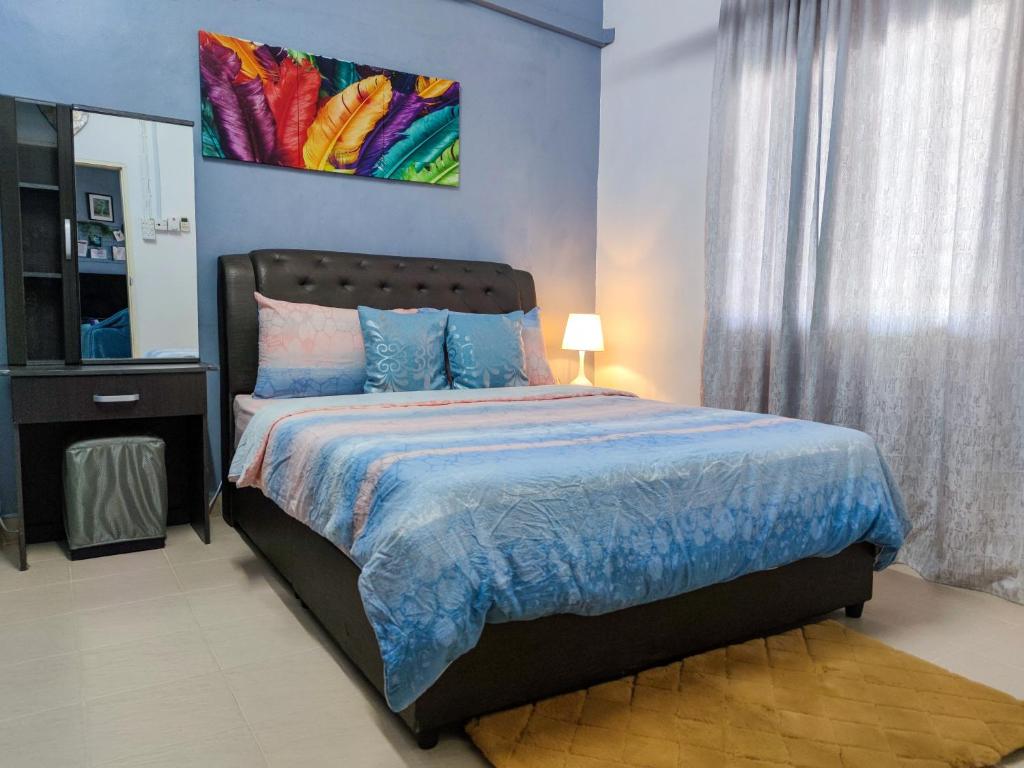 a bedroom with a bed and a painting on the wall at The Hidden Gems in Pantai Cenang