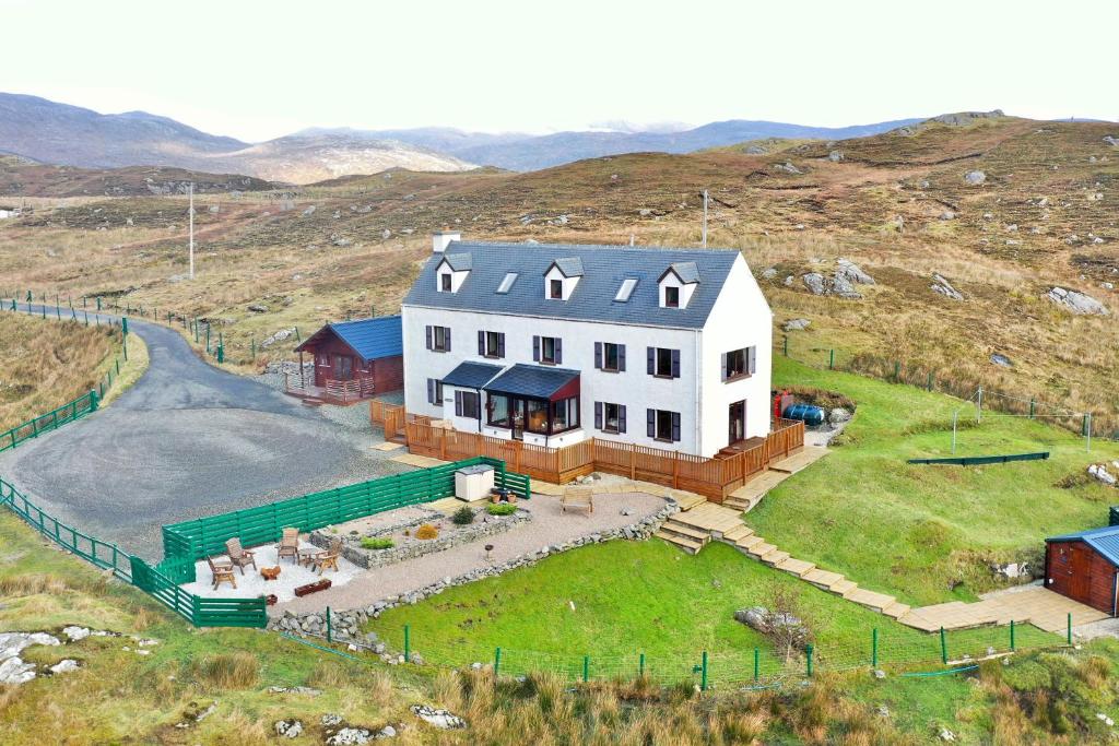 an aerial view of a large white house on a hill at Ceol na Mara Guest House in Tarbert