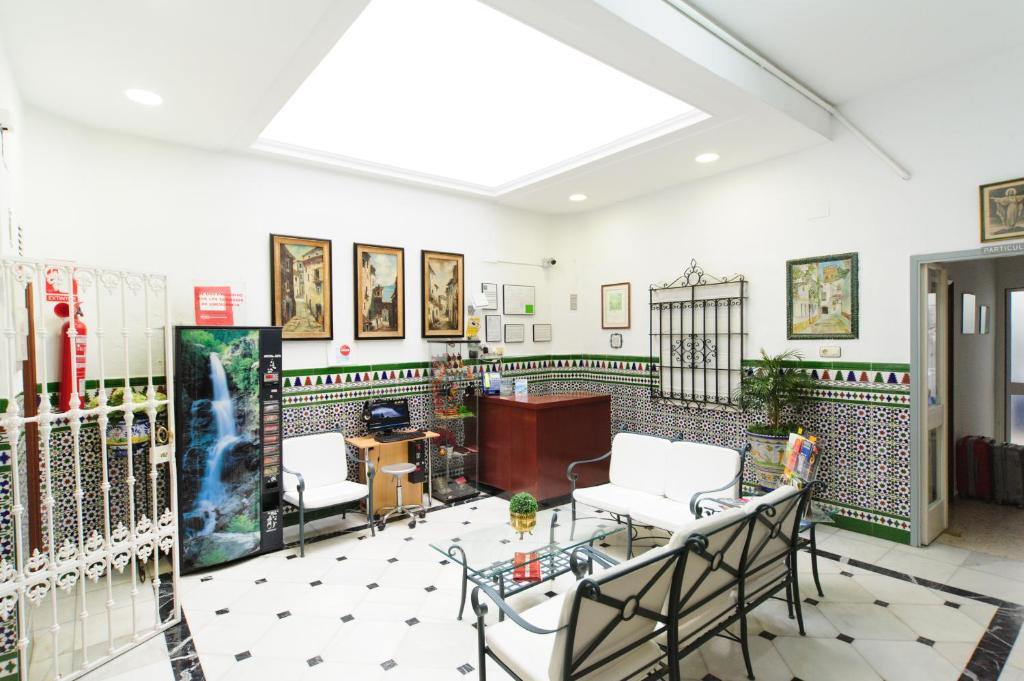 a room with two chairs and a table in it at Pension Gala in Seville