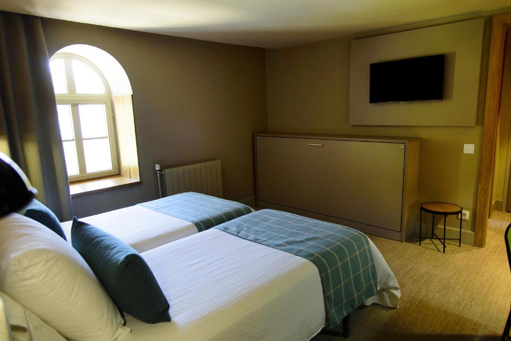 Postel nebo postele na pokoji v ubytování Hotel Vall de Núria