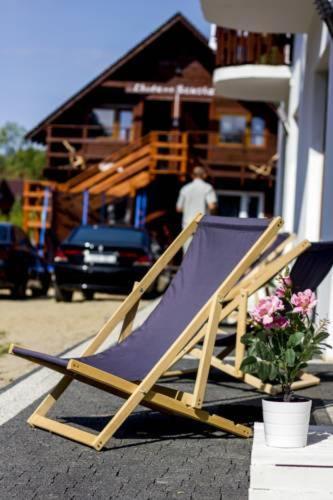 a folding chair sitting on the ground next to a house at Willa Bryza Rewa in Rewa