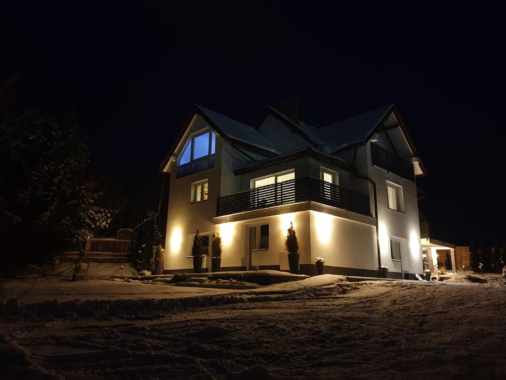 a large house at night with lights on it at Noclegi AGA in Polańczyk